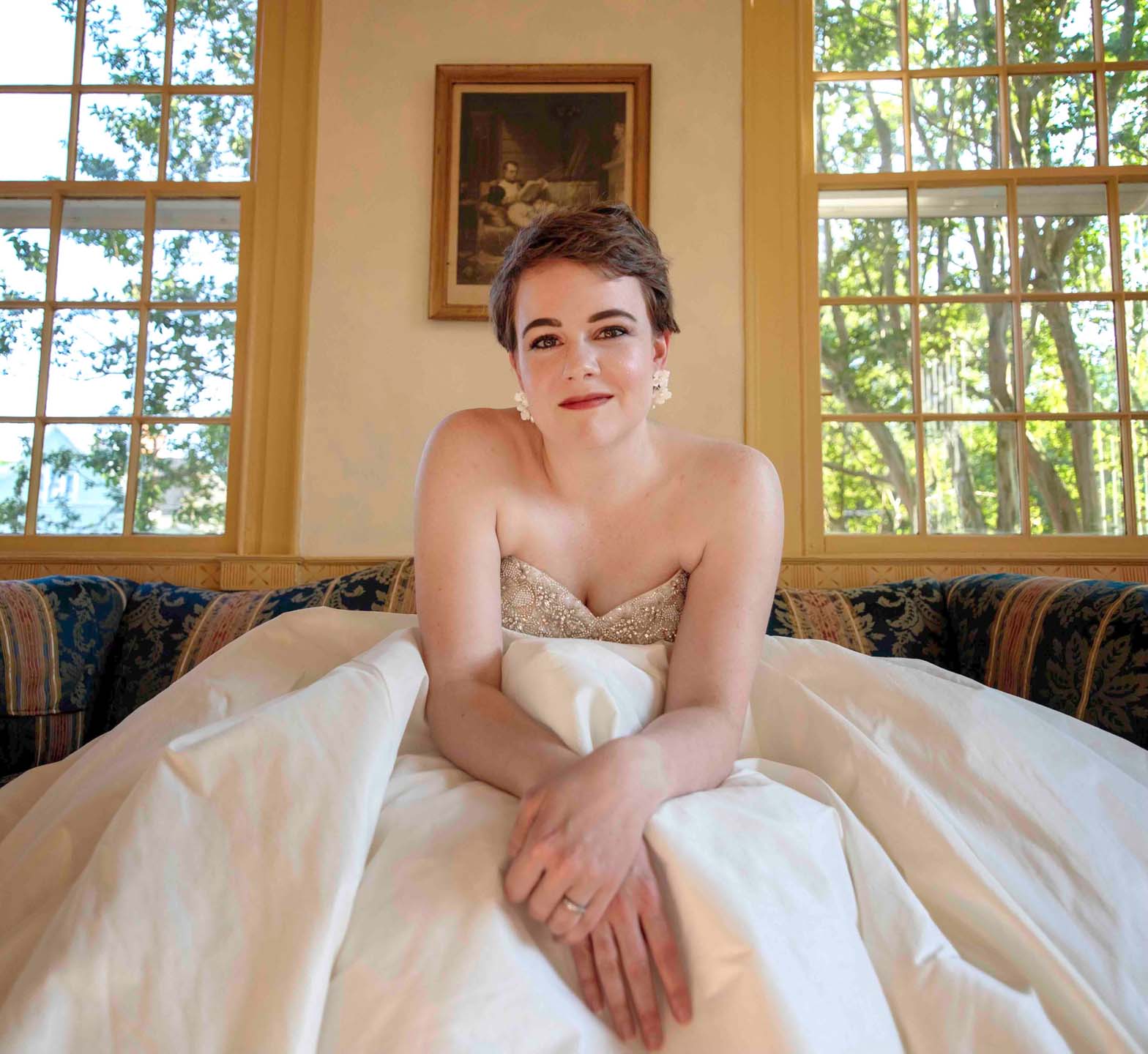 Susanna in white bridal dress posing for team headshots.